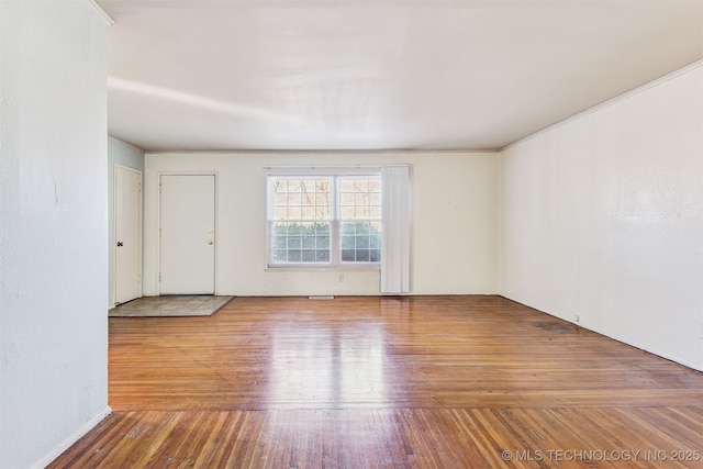 empty room with hardwood / wood-style flooring