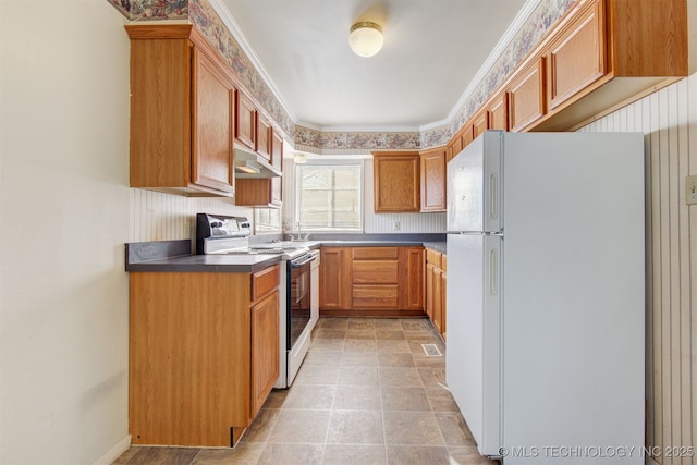 kitchen with electric range oven, crown molding, and white refrigerator