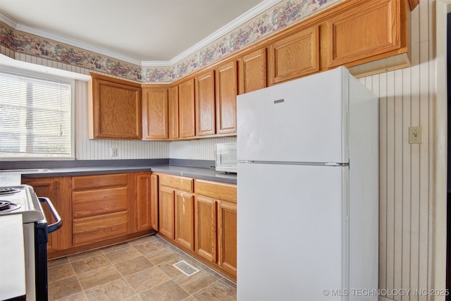 kitchen with white refrigerator and electric stove