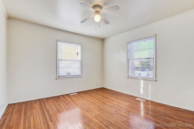 spare room featuring crown molding, hardwood / wood-style flooring, plenty of natural light, and ceiling fan