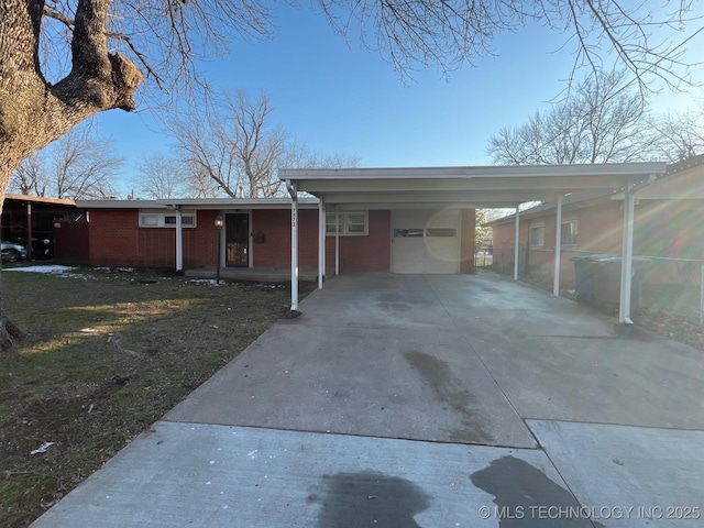 ranch-style house featuring a carport and a garage