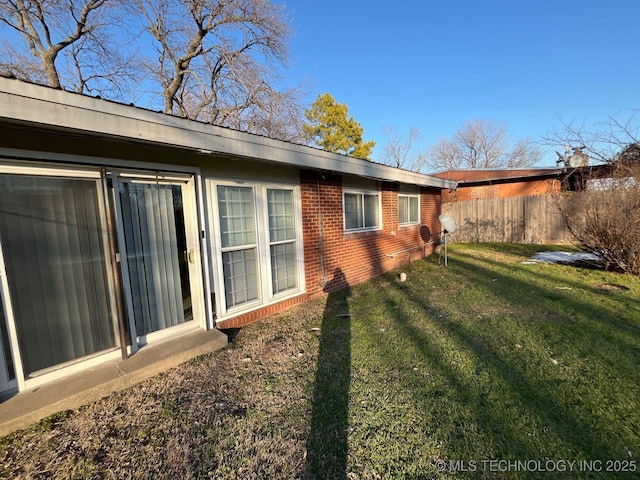 view of home's exterior with a yard