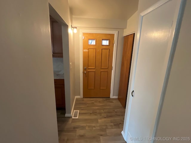 hallway with hardwood / wood-style flooring