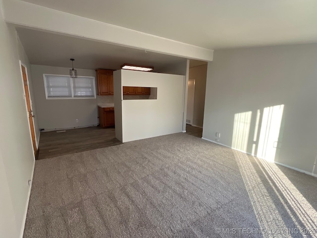 unfurnished living room with dark carpet