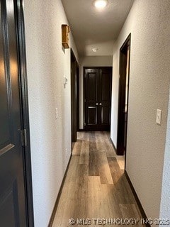 corridor with light wood-type flooring