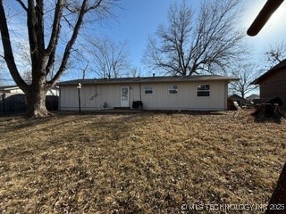 rear view of house with a lawn