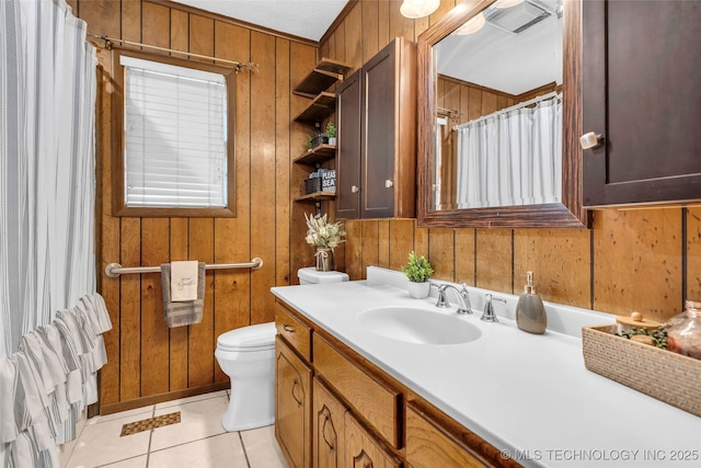 bathroom featuring vanity, toilet, tile patterned flooring, and wood walls