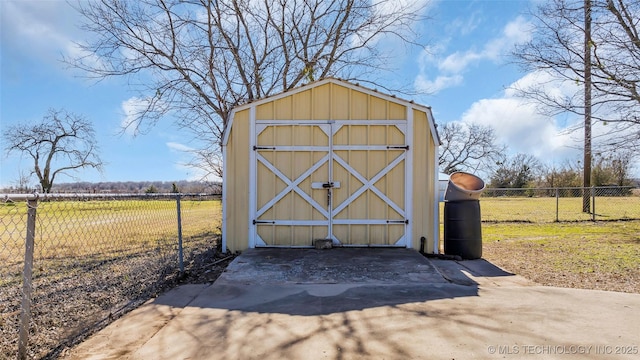 view of outbuilding with a rural view and a yard