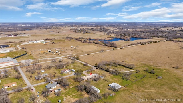 birds eye view of property featuring a water view and a rural view