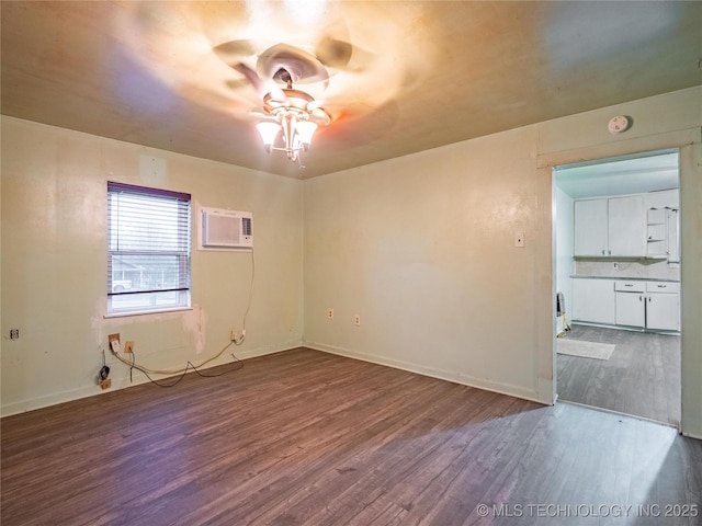 spare room featuring hardwood / wood-style flooring, ceiling fan, and a wall mounted AC