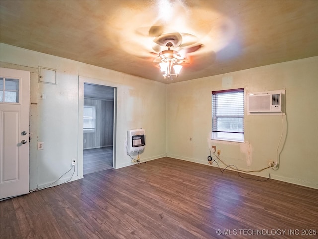 interior space featuring wood-type flooring, heating unit, ceiling fan, and a wall unit AC