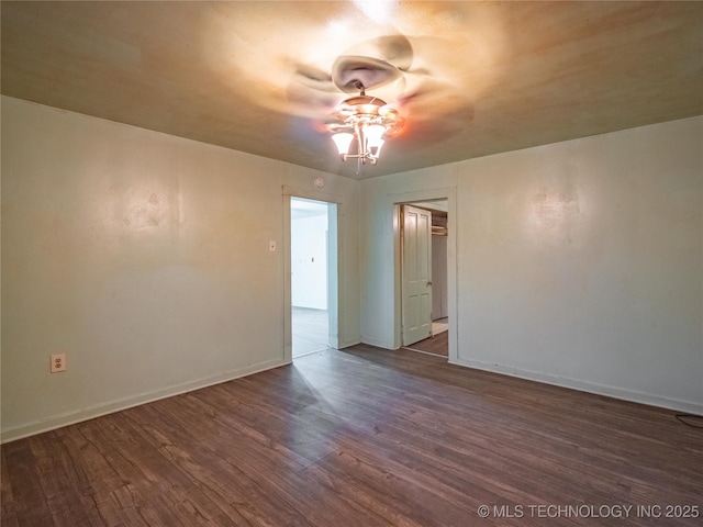 unfurnished room featuring dark wood-type flooring and ceiling fan