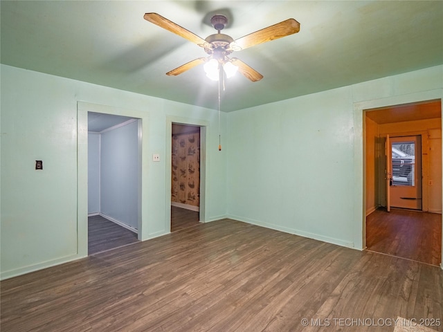 unfurnished room featuring ceiling fan and dark hardwood / wood-style flooring