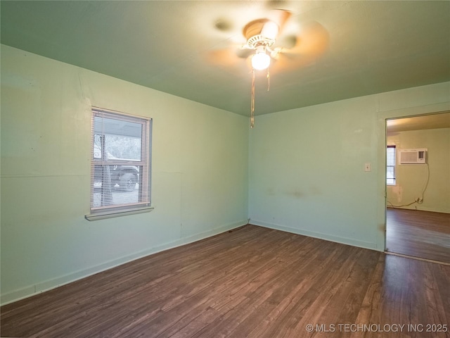 unfurnished room featuring ceiling fan, dark hardwood / wood-style flooring, a wall unit AC, and a wealth of natural light