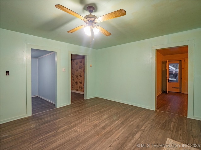 spare room featuring dark hardwood / wood-style floors and ceiling fan