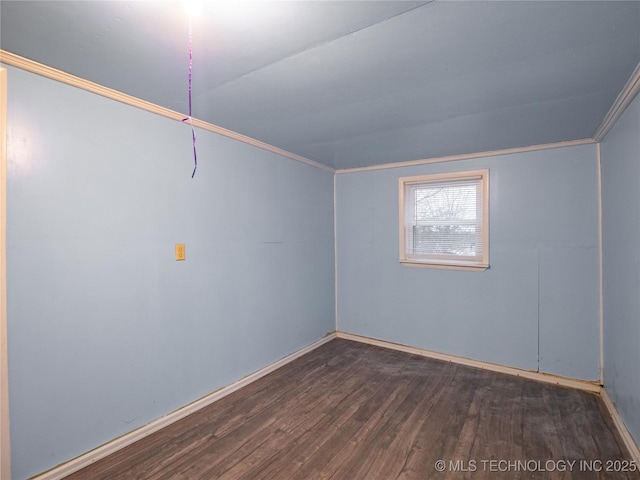 empty room with ornamental molding and dark hardwood / wood-style floors