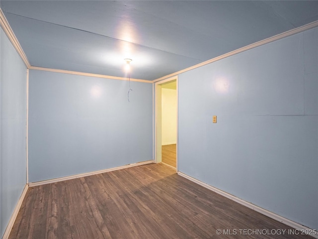 spare room featuring crown molding and wood-type flooring