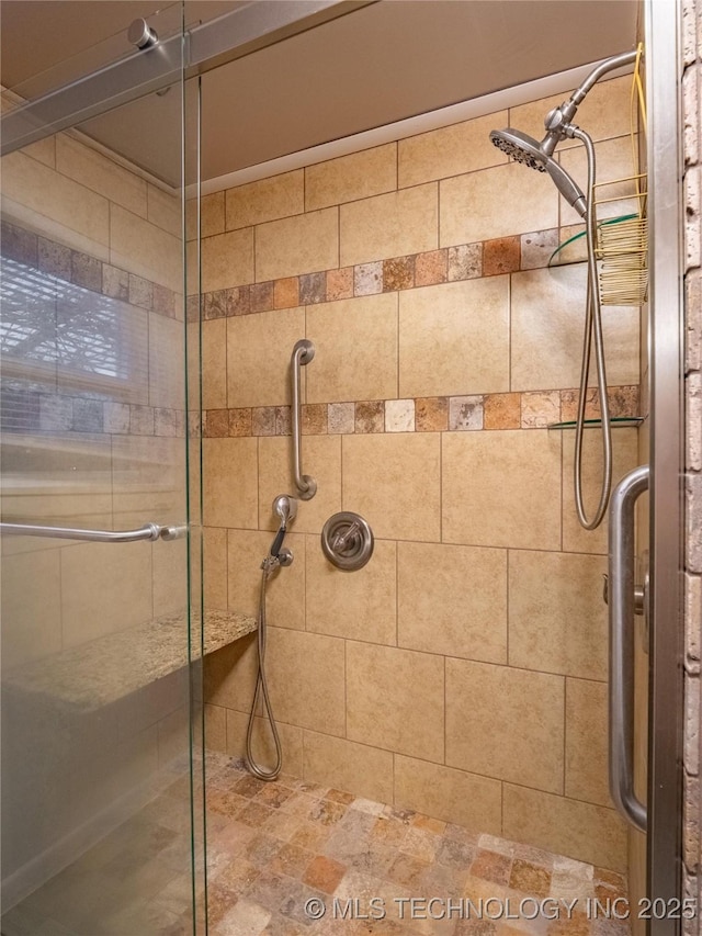 bathroom with a shower with door