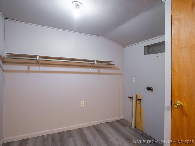 laundry room with hookup for a washing machine and light hardwood / wood-style flooring