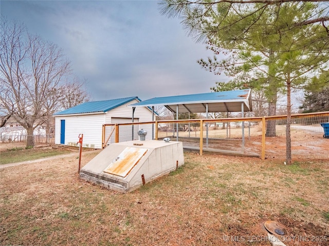 view of storm shelter featuring an outdoor structure and a yard