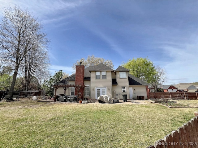 rear view of property with a gazebo, a yard, and a patio area