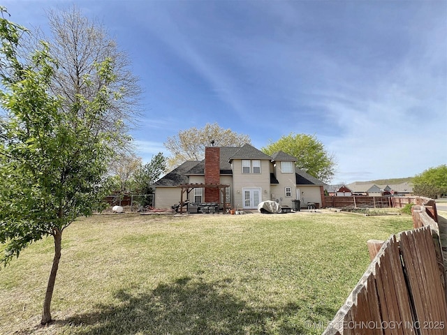 rear view of house with a yard