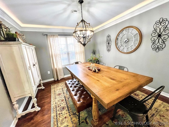 dining space featuring crown molding, an inviting chandelier, and dark wood-type flooring