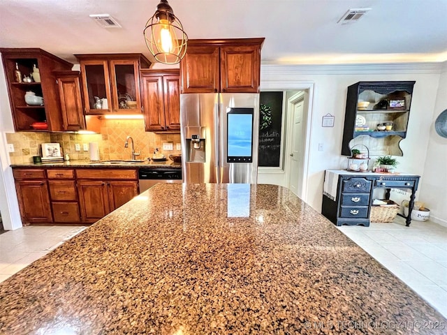 kitchen with sink, dark stone countertops, pendant lighting, stainless steel appliances, and backsplash