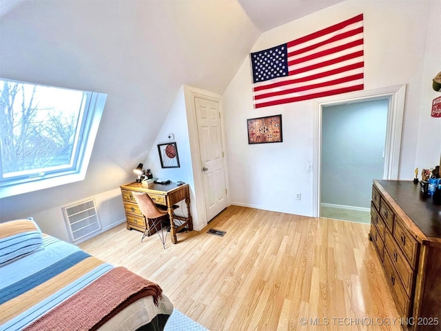 bedroom with lofted ceiling and light hardwood / wood-style flooring