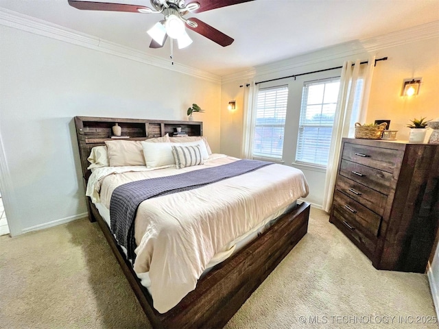 carpeted bedroom featuring crown molding and ceiling fan