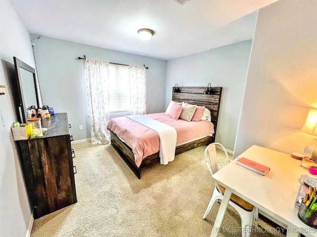 bedroom featuring light carpet