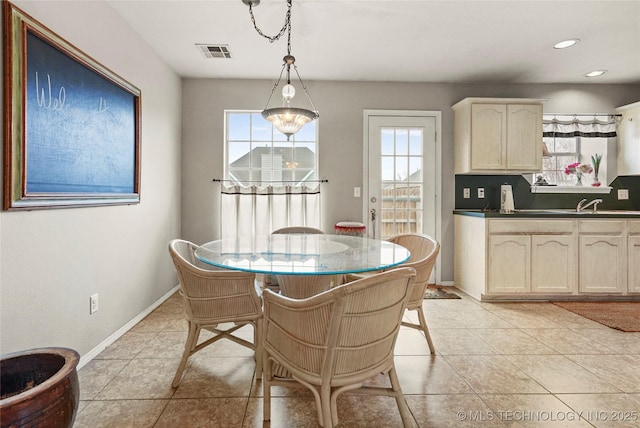 tiled dining space with a healthy amount of sunlight