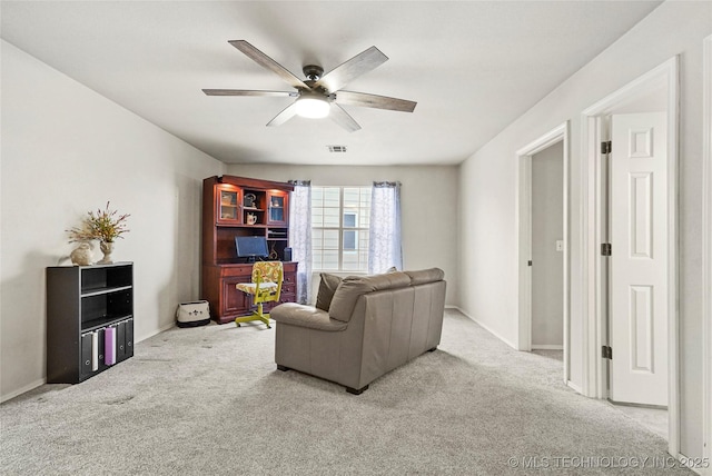 carpeted living room featuring ceiling fan