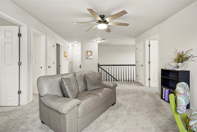 carpeted living room with ceiling fan