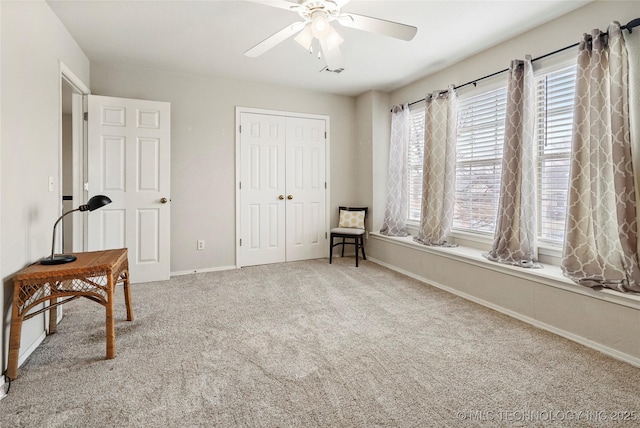 sitting room featuring carpet and ceiling fan