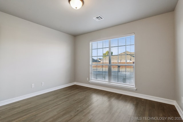 unfurnished room featuring dark hardwood / wood-style floors