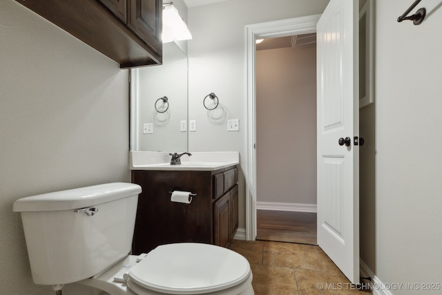 bathroom featuring vanity, tile patterned flooring, and toilet