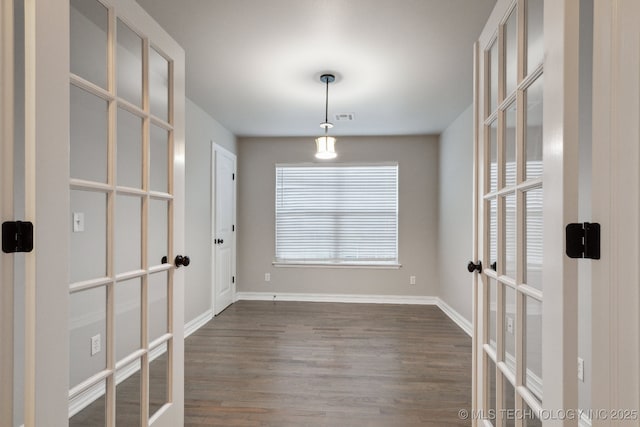 interior space with dark wood-type flooring and french doors