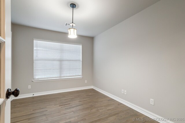 empty room with french doors and dark wood-type flooring