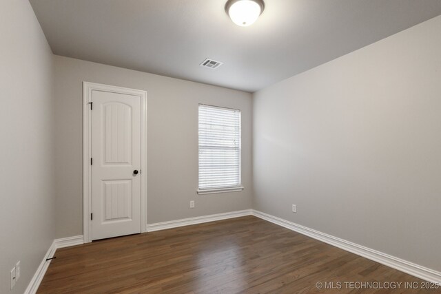 unfurnished room featuring hardwood / wood-style flooring