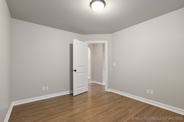 spare room featuring dark hardwood / wood-style floors