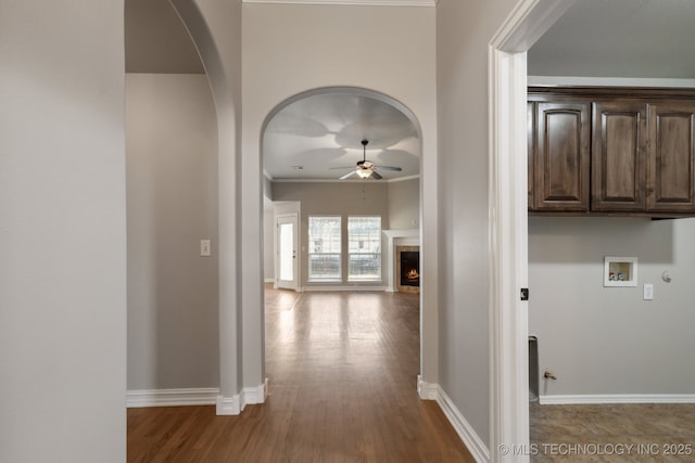 hall with crown molding and hardwood / wood-style floors