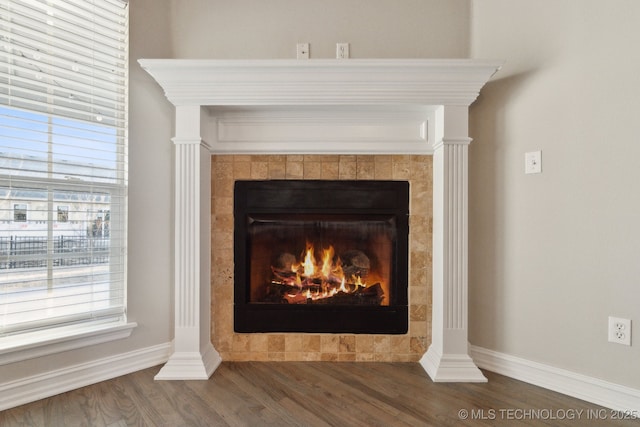 interior details with hardwood / wood-style flooring and a fireplace