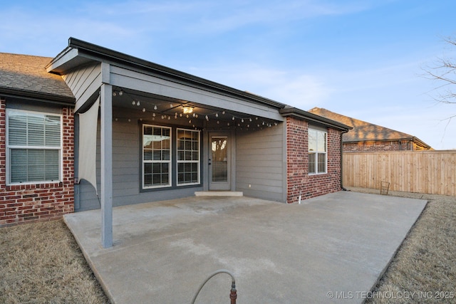 back of house with ceiling fan and a patio area