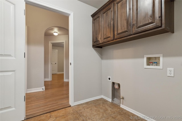 clothes washing area featuring hookup for a washing machine, electric dryer hookup, light tile patterned floors, and cabinets