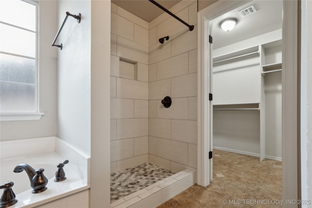 bathroom featuring independent shower and bath