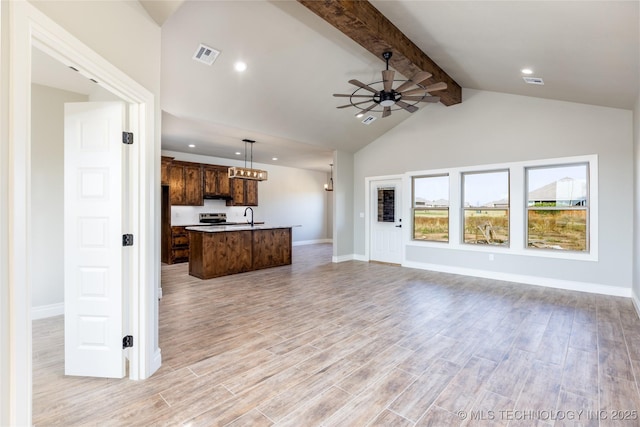 unfurnished living room featuring ceiling fan, sink, vaulted ceiling with beams, and light hardwood / wood-style floors