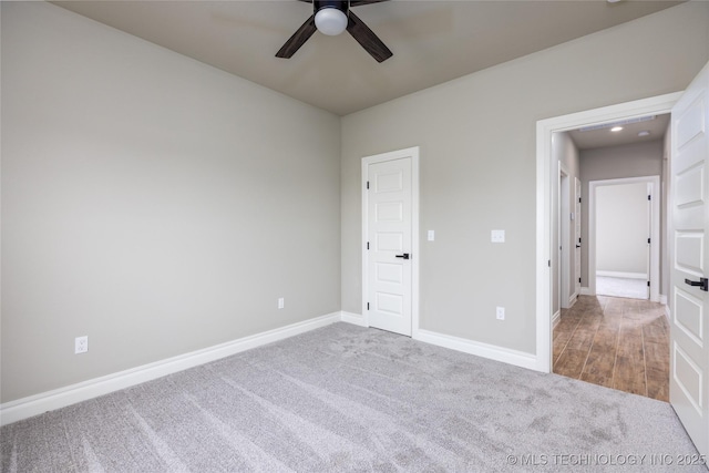 unfurnished bedroom featuring light colored carpet and ceiling fan