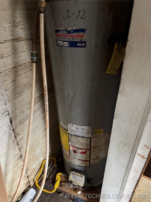 utility room featuring water heater