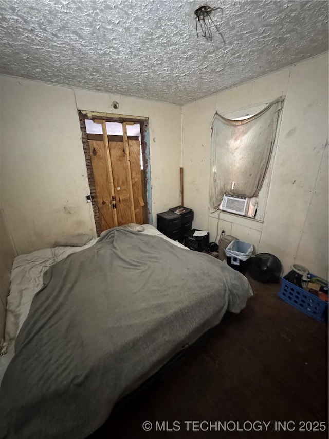 bedroom featuring cooling unit and a textured ceiling